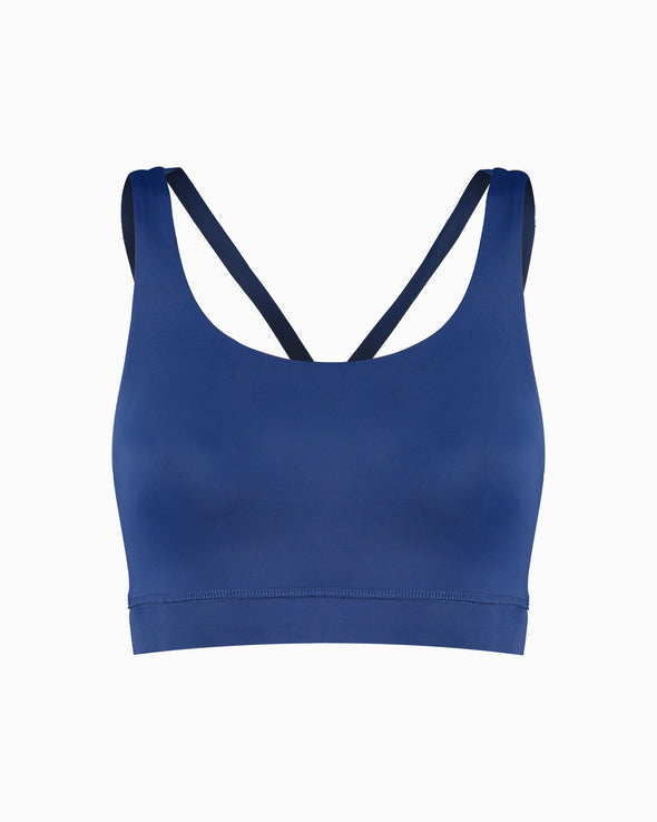 Blue sustainable women’s sports bra. Women’s Activewear made to last with ECONYL Regenerated Yarn created with recovered fishing nets.  Front view.