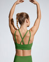 Green sports bra for women. Featuring cross back detail and low scoop neckline. Scultura Activewear 