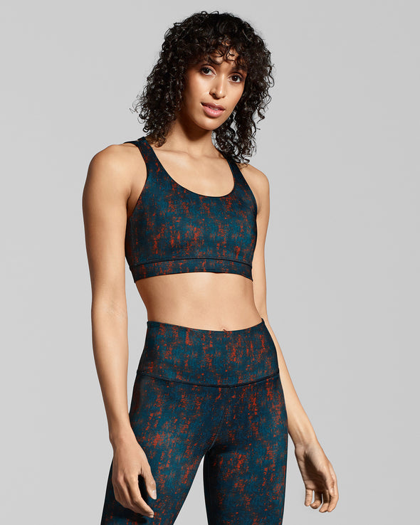 Sienna sports bra. Luxury activewear Collection made from sustainable fabric. Women's gym wear print in dark blue and burnt orange. 