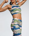 Camufarre Sustainable Sports Crop. Featuring a one off camo activewear print design created with a purpose by Scultura. Inspired by the ocean and designed to raise awareness of the environmental impact of single use plastic. Created with premium technical Italian fabric made with 100% regenerated yarn from recycled plastic bottles (rPET). 