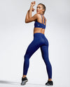 Model wearing blue Debutto sustainable gym leggings. Full length Gym Legging. Sustainable Activewear made to last with ECONYL Regenerated Yarn.  Side view.