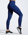 Side view of model wearing blue gym leggings made with sustainable fabric created with recovered fishing nets. Full length blue sports leggings. Sustainable activewear thats designed and made to last in the UK.