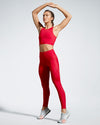 Model wearing red Debutto sustainable gym leggings. Full length Gym Legging. Sustainable Activewear made to last with ECONYL Regenerated Yarn.  Front view.