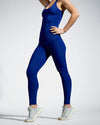Model wearing blue sustainable gym top. Energia, a full length racer back sports top. Women’s Sustainable Activewear made to last with ECONYL Regenerated Yarn.  Side view.