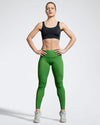 Sustainable black sports bra featuring cross back straps. Model wearing sustainable gym bra. Made in the UK with Premium Italian sportswear fabric created with ECONYL regenerated yarn.