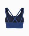 Product shot of blue sustainable women’s sports bra. Women’s Activewear made to last with ECONYL Regenerated Yarn created with recovered fishing nets.  back view featuring cross back straps.