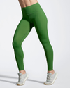 Model wearing olive green Debutto gym leggings. Women's Full length Gym Legging. Sustainable Activewear made to last with ECONYL Regenerated Yarn.  Side view.