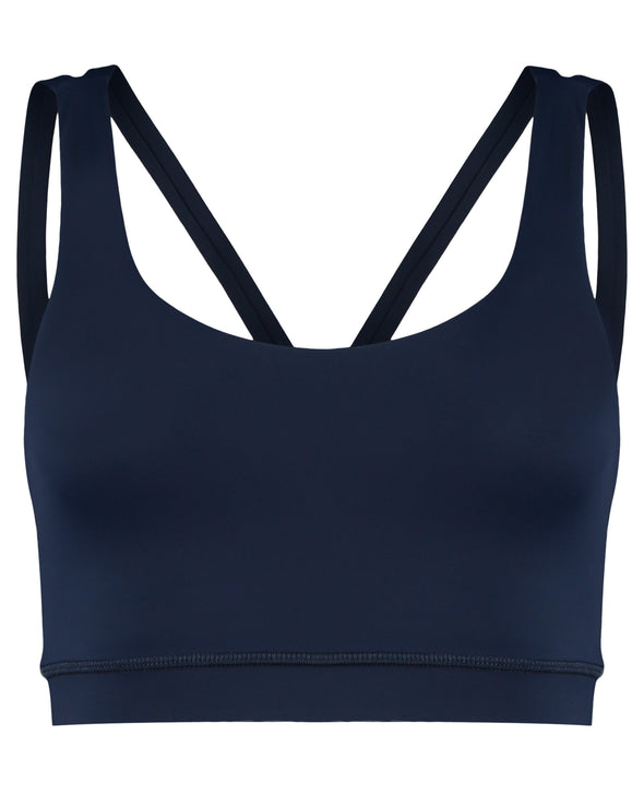Dark blue navy sustainable sports bra with cross back straps. Premium sustainable activewear in deep blue. Product image.