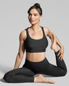 Women’s Pebble grey activewear set in yoga pose. Sustainable sports bra and leggings for yoga, gym, workout, walking, running and fitness training. Sustainable multi sport gym wear set.