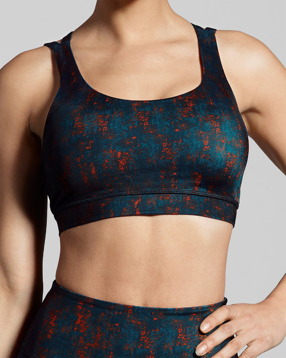 Sienna sports bra print. Close up. Deep blue and burnt orange sustainable gym bra print. Luxury gym clothes made to last.