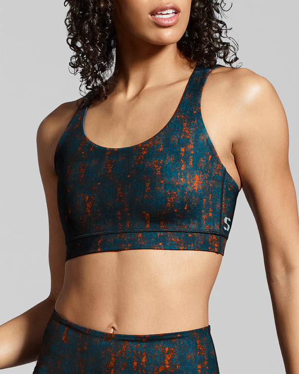 Sienna print ladies gym bra. Made with sustainable fabric. Dark ocean blue and burnt orange sportswear print from New horizons activewear collection.