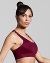 Side view of eco friendly fitness and sports bra in dark red burgundy. Designed with sustainable fabric made with ECONYL® regenerated yarn.