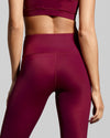 Close up back view of berry gym leggings. Designed in the UK with fabric made with ECONYL® regenerated yarn.