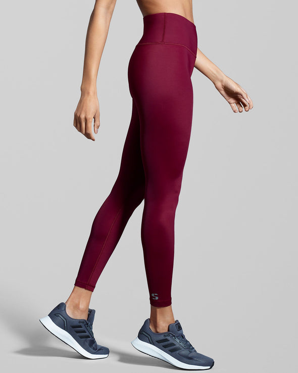 Side view of eco friendly fitness leggings in true berry red. Designed with sustainable fabric made with ECONYL® regenerated yarn.
