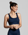 Sustainable sports bra in deep blue navy, Front view of women wearing navy blue activewear made with sustainable fabric. 