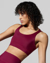 Close up view of berry burgundy gym bra. sustainable sports crop. Designed in the UK with fabric made with ECONYL® regenerated yarn.