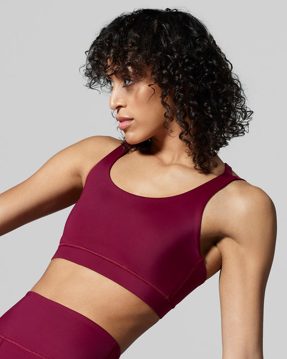Close up back view of berry gym gym bra. Designed in the UK with fabric made with ECONYL® regenerated yarn. Garnet sustainable sports bra.